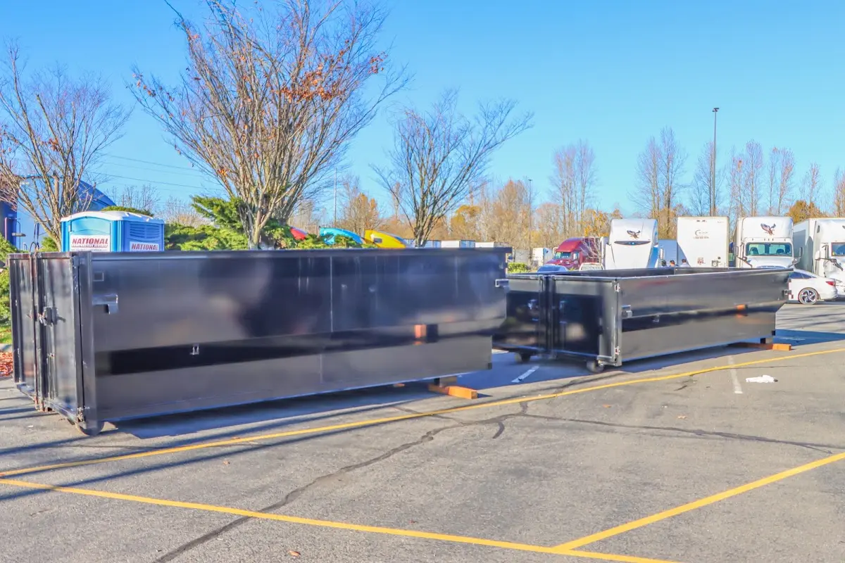 Professional dumpster rental service with roll-off container on residential driveway in Robbinsville